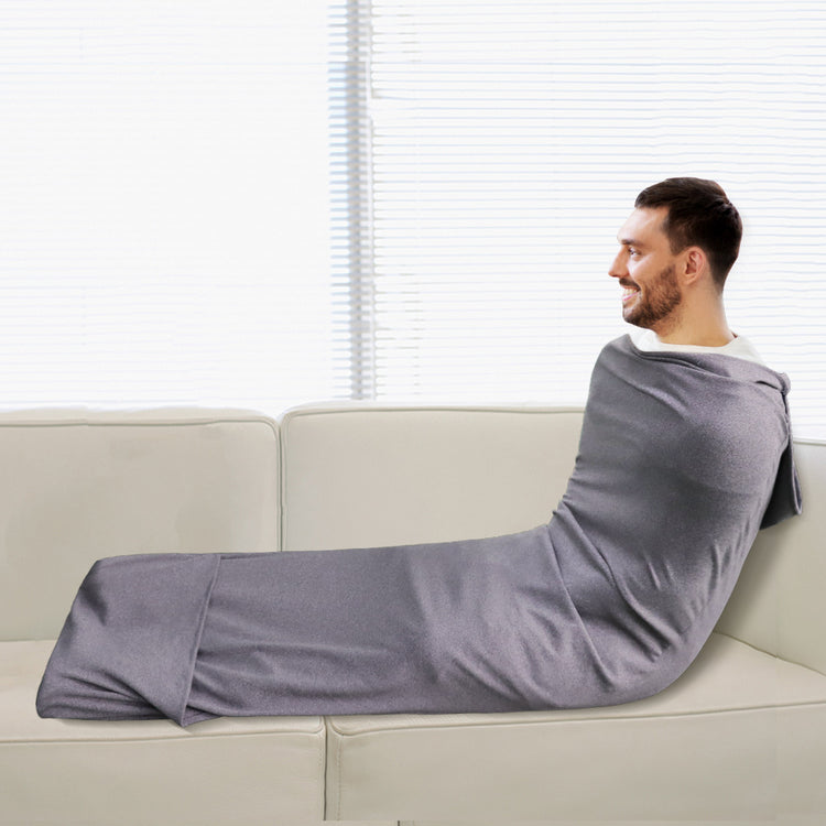 a man wrapped in a blanket on a couch