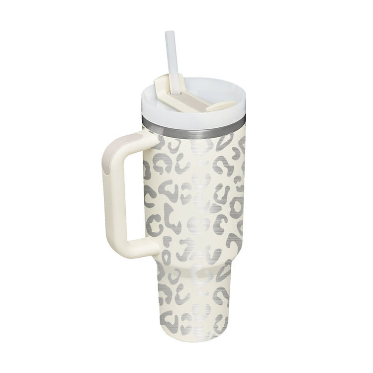 a white and grey leopard print travel mug with a straw