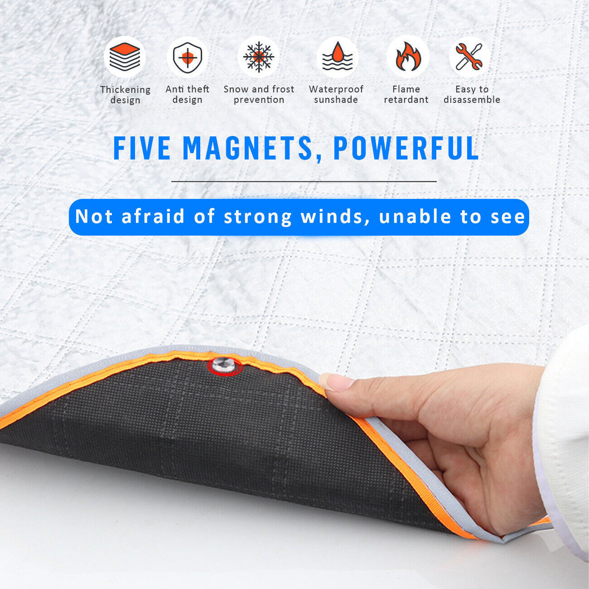 a hand holding a black and orange fabric