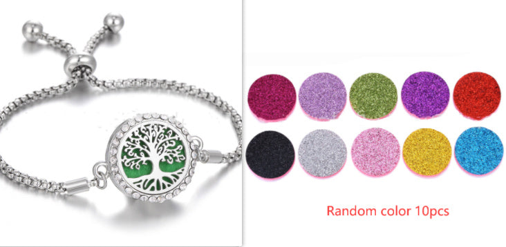 a silver bracelet with a tree of life