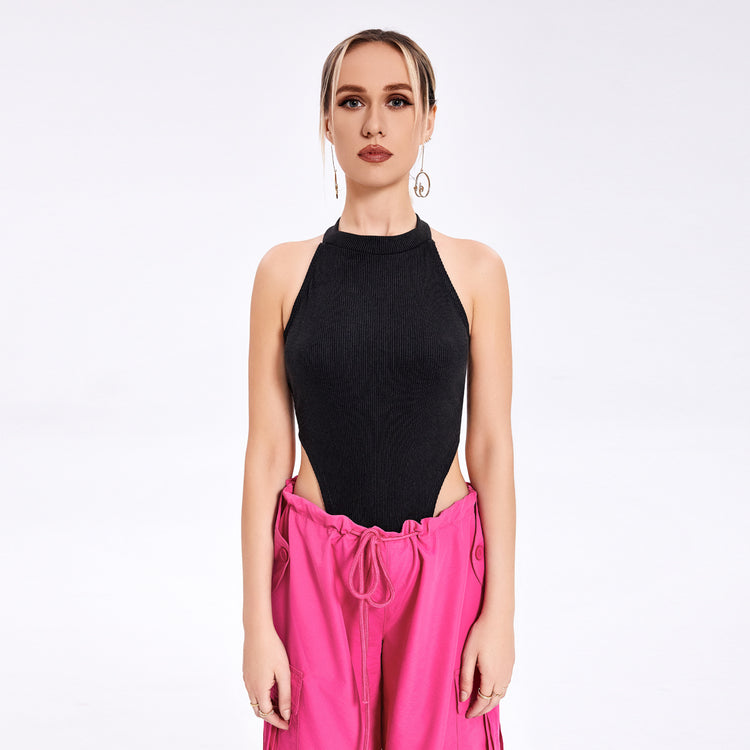 a woman in a black top and pink pants