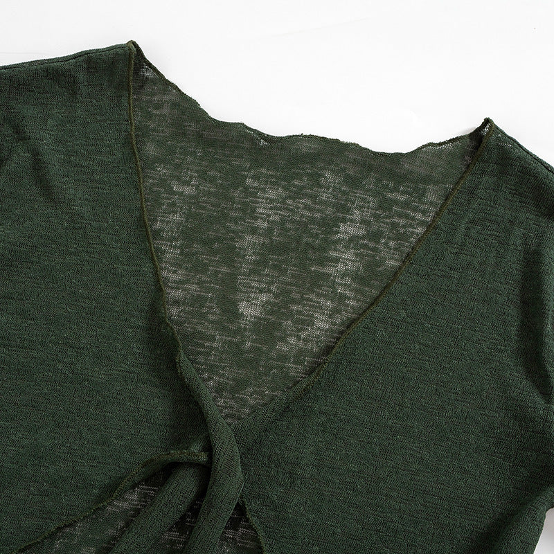 a green sweater with a criss cross neck