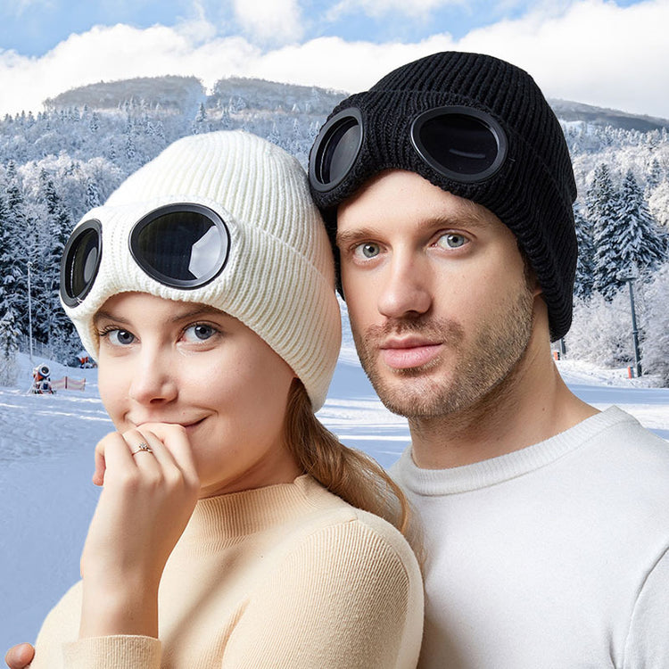 a man and woman wearing goggles and a hat