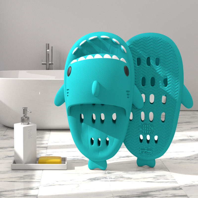 a blue shark shaped object next to a bathtub