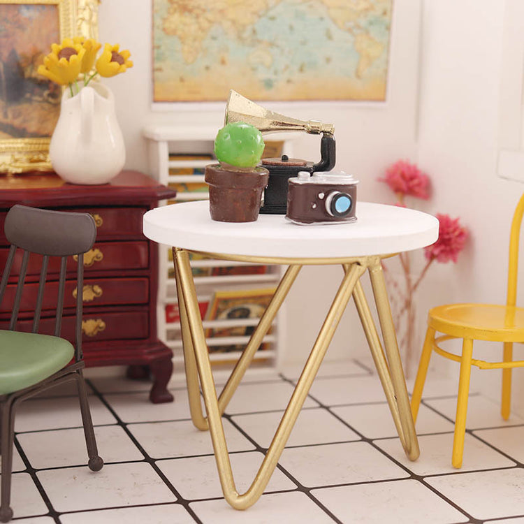 a small table with a camera and a yellow chair