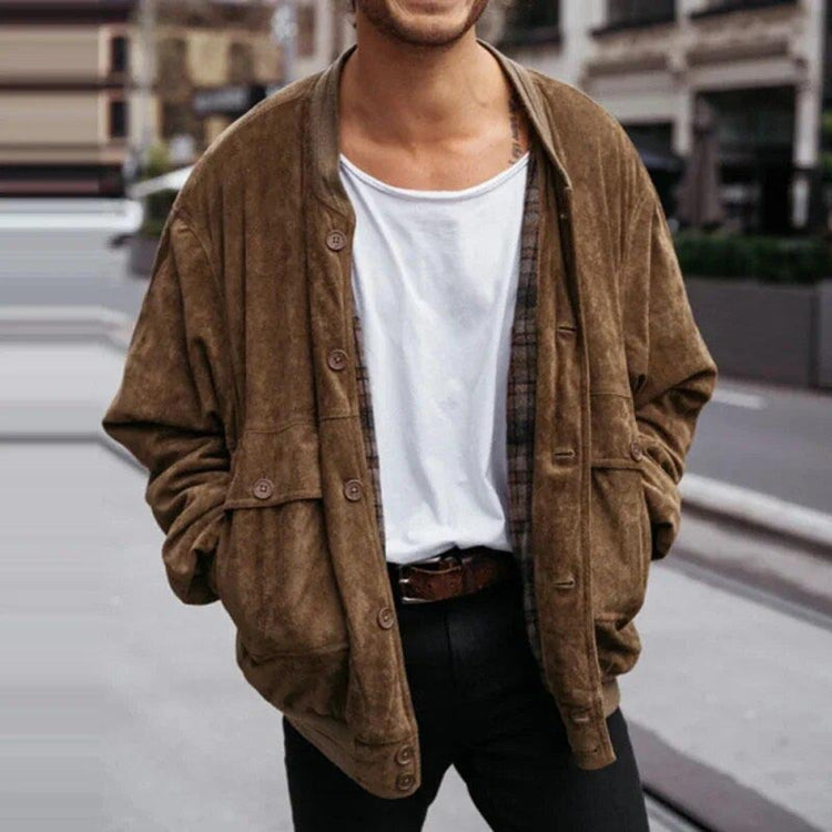 a man standing outside with his hands in his pockets
