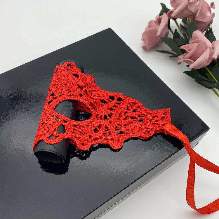 a red mask on a black book