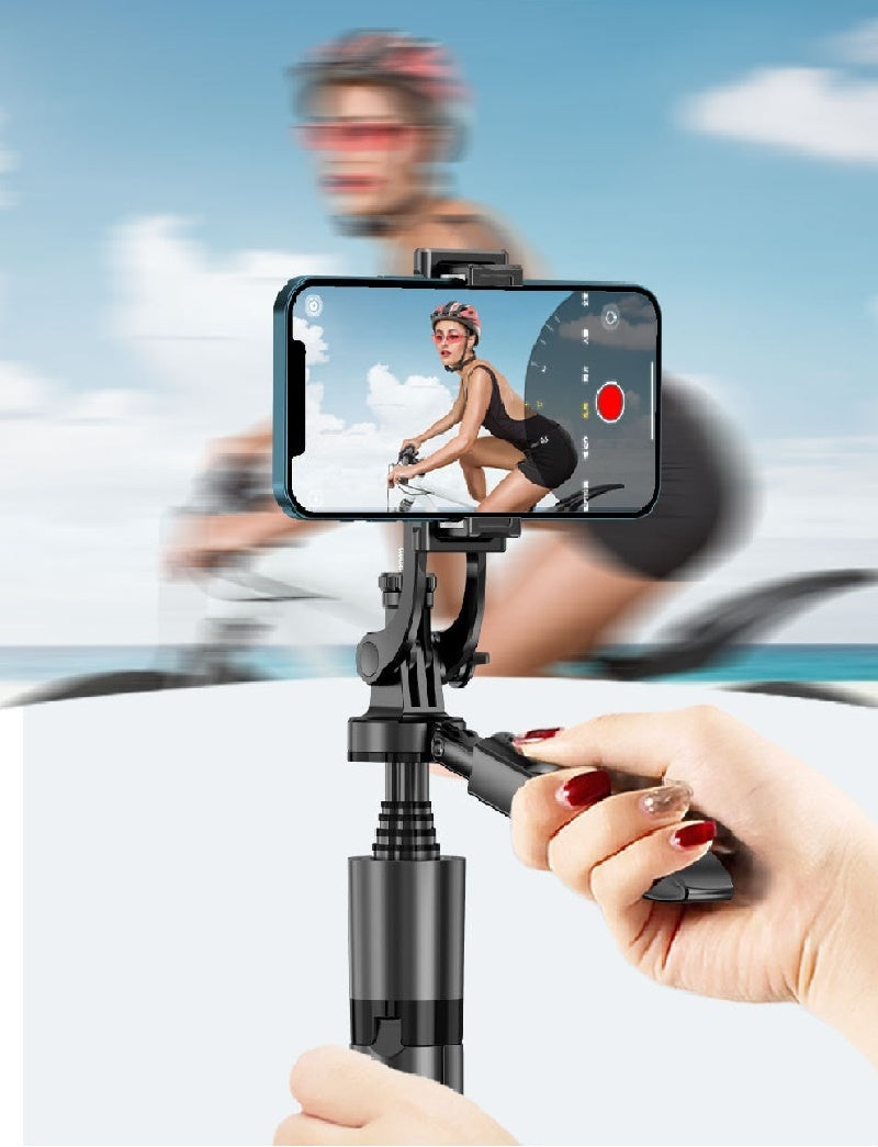 a hand holding a phone to a selfie stick