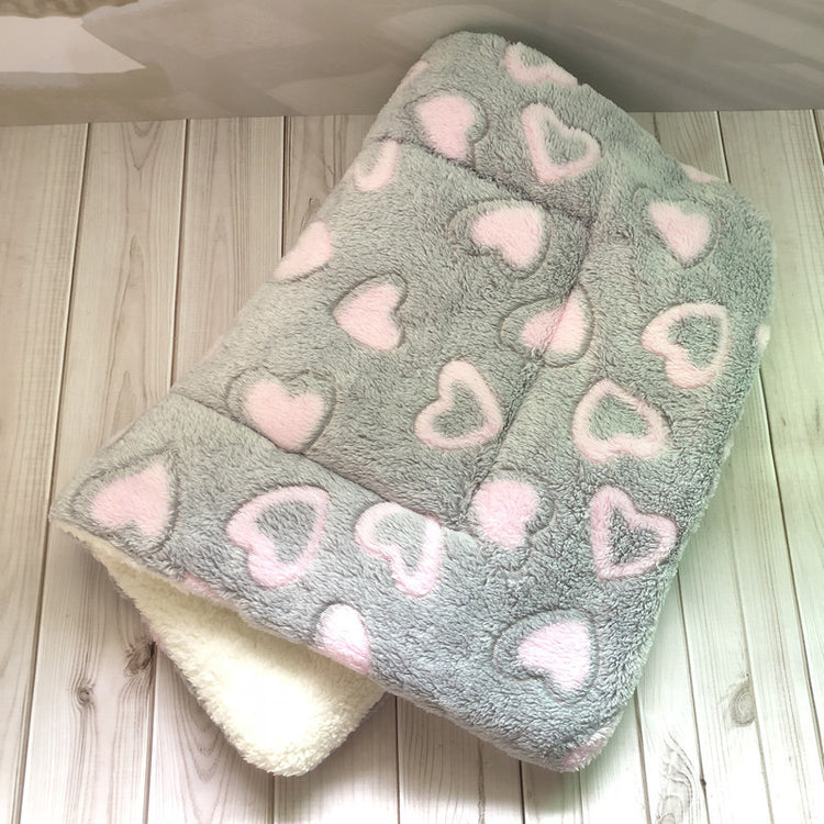 a blanket on a wood surface