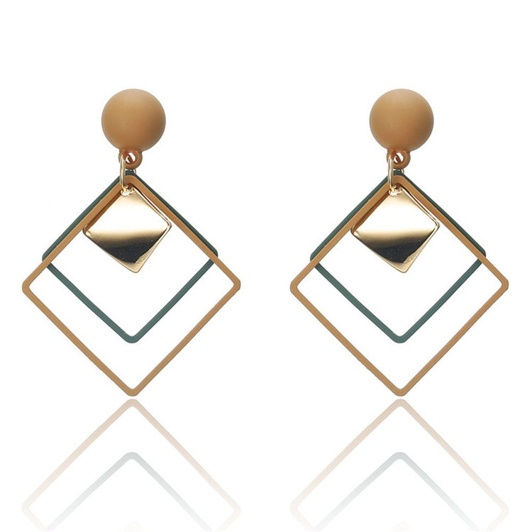a pair of earrings with a square shape