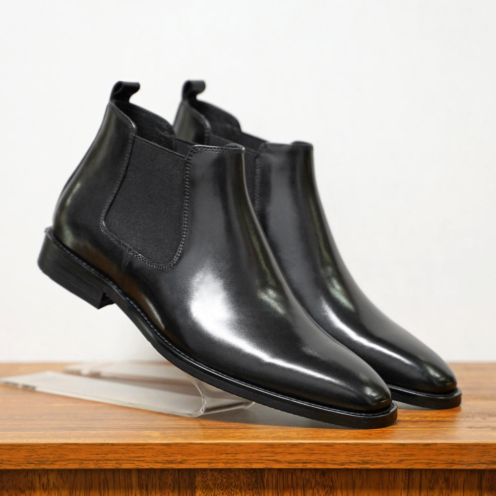 a pair of black leather boots on a stand