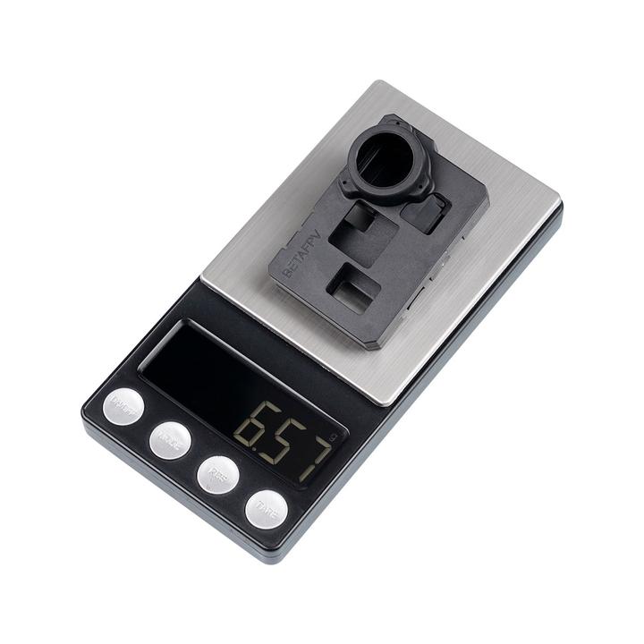 a small scale with a screen and a small black object