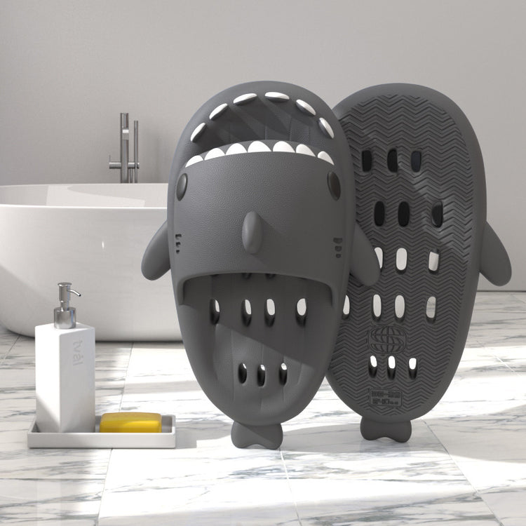 a grey animal shaped object next to a bathtub