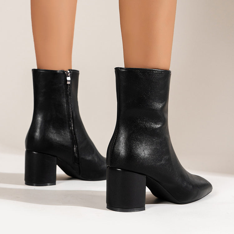 a pair of legs wearing black boots