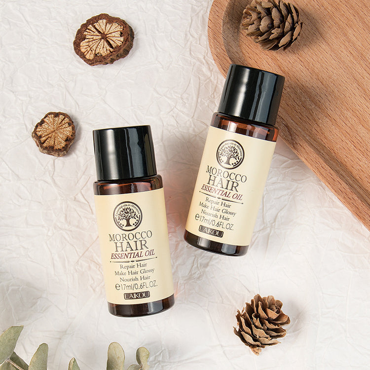 bottles of hair oil next to pine cones