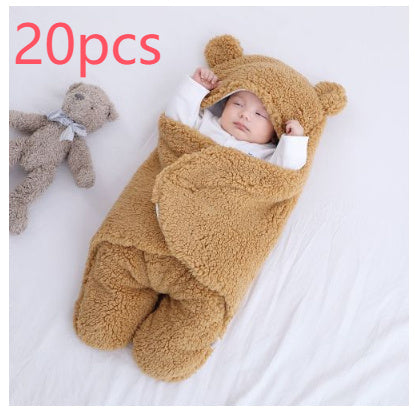 a baby sleeping in a bear blanket