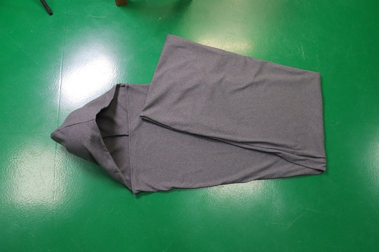 a grey hooded sweatshirt on a green surface
