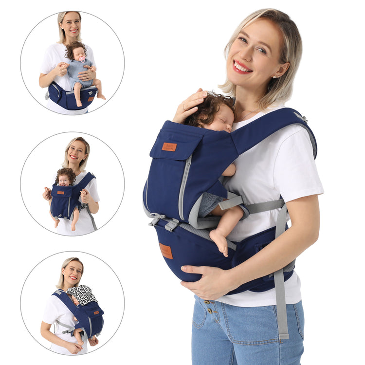 a woman holding a baby in a baby carrier