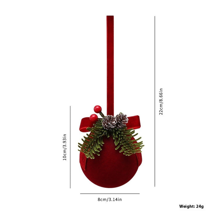 a red christmas ornament with a ribbon and pinecones