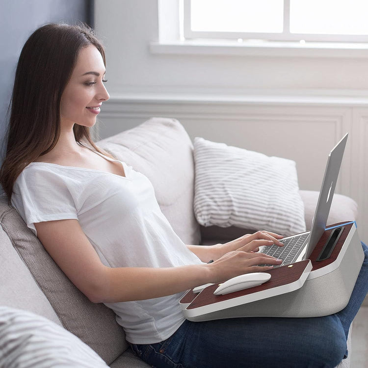 a woman sitting on a couch using a laptop