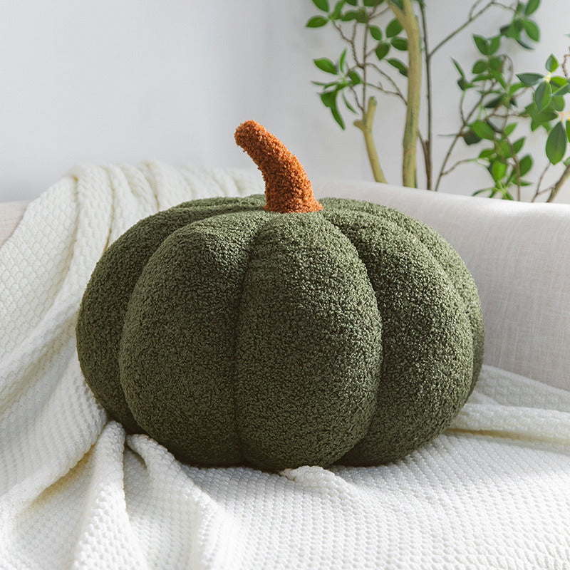 a green pumpkin on a white blanket