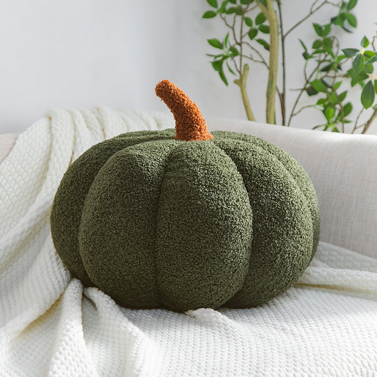 a green pumpkin on a white blanket