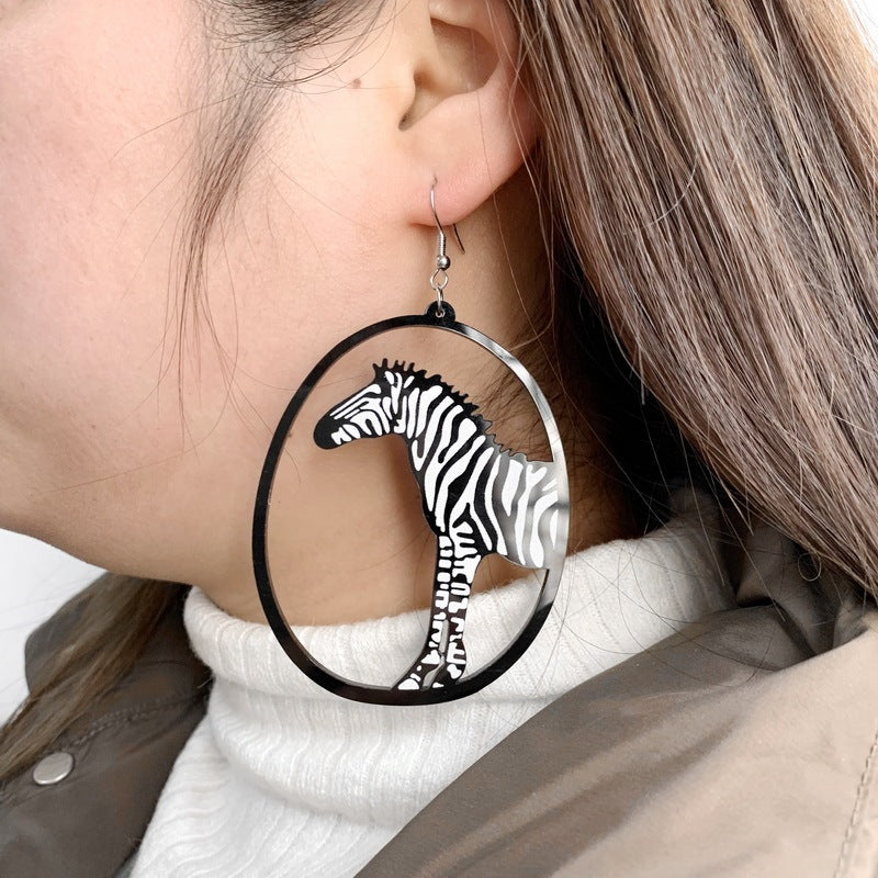 a woman wearing a zebra earring