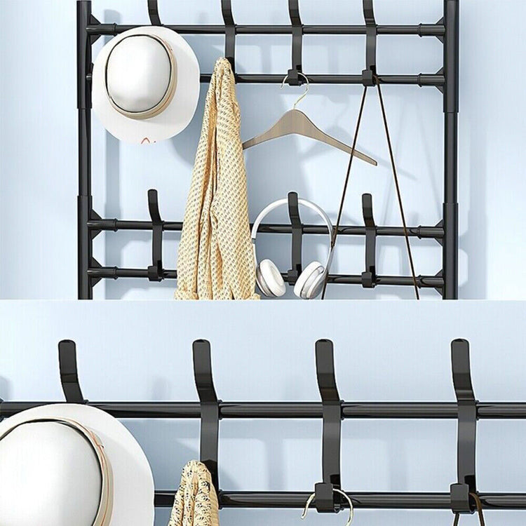 a black metal coat rack with hats and hats on it