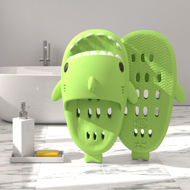 a green animal shaped object next to a white bathtub