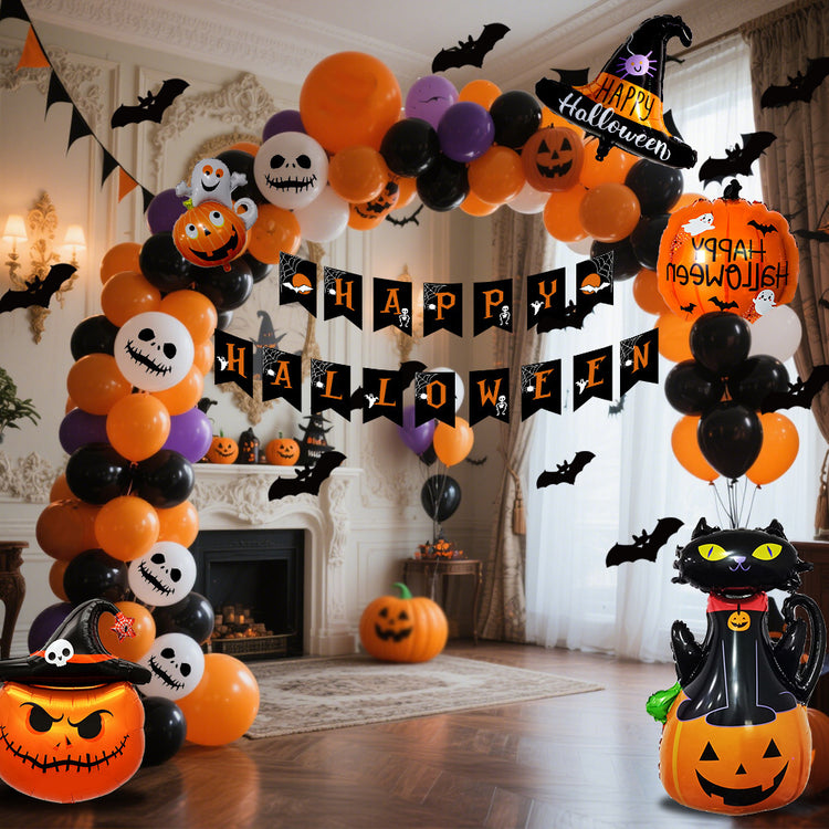 a room with a large archway with balloons and a cat and pumpkins