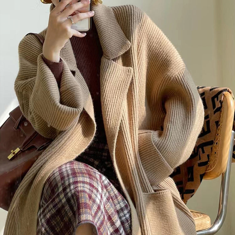 a woman sitting in a chair taking a selfie
