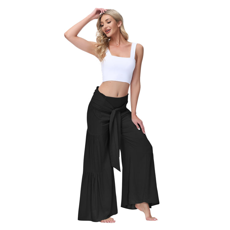 a woman in a white top and black pants
