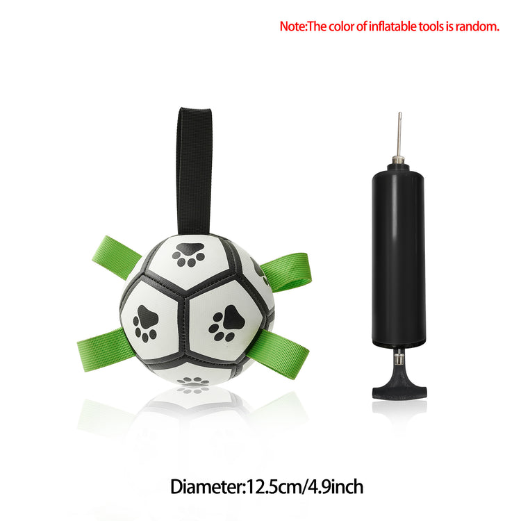 a ball with a green ribbon next to a black pump