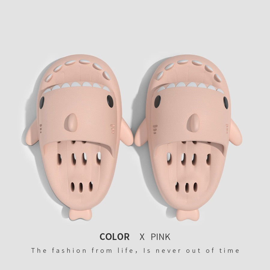 a pair of slippers with a shark face