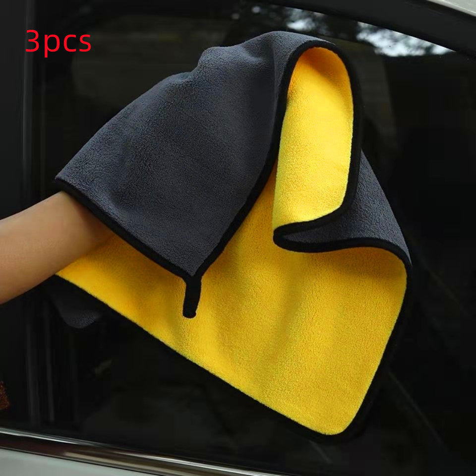 a hand holding a yellow and black towel