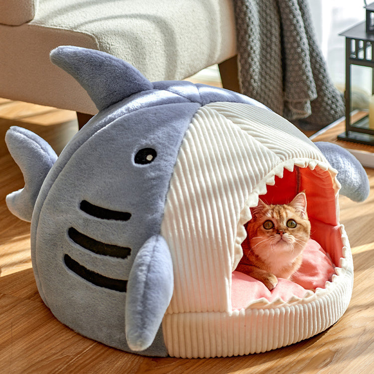 a cat in a stuffed animal bed