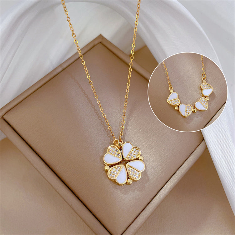 a gold necklace with a flower pendant on it