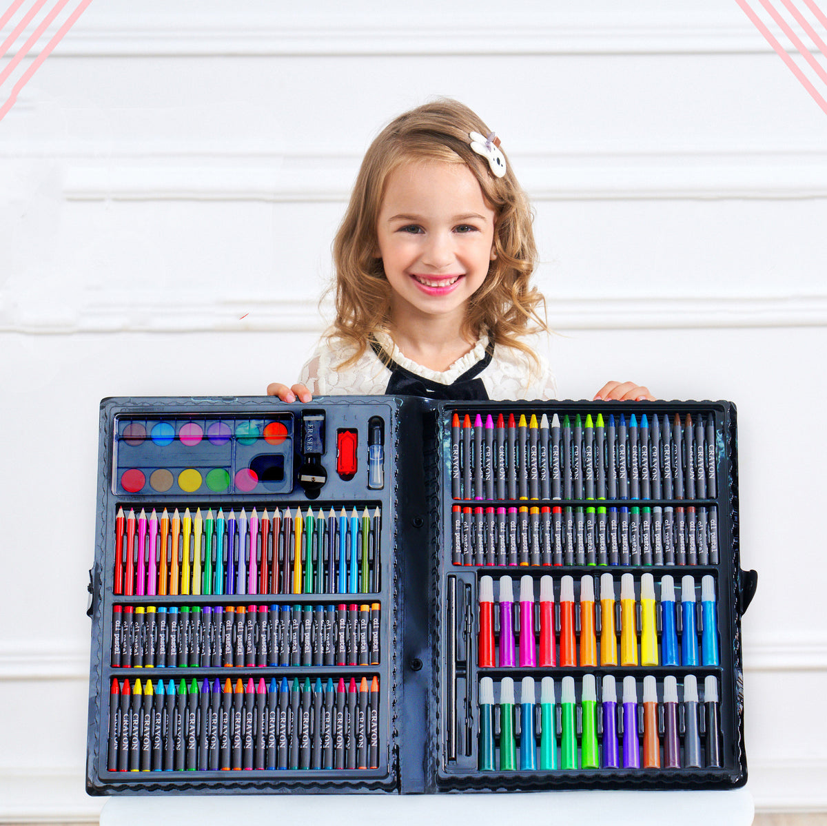 a girl holding a set of colored pencils