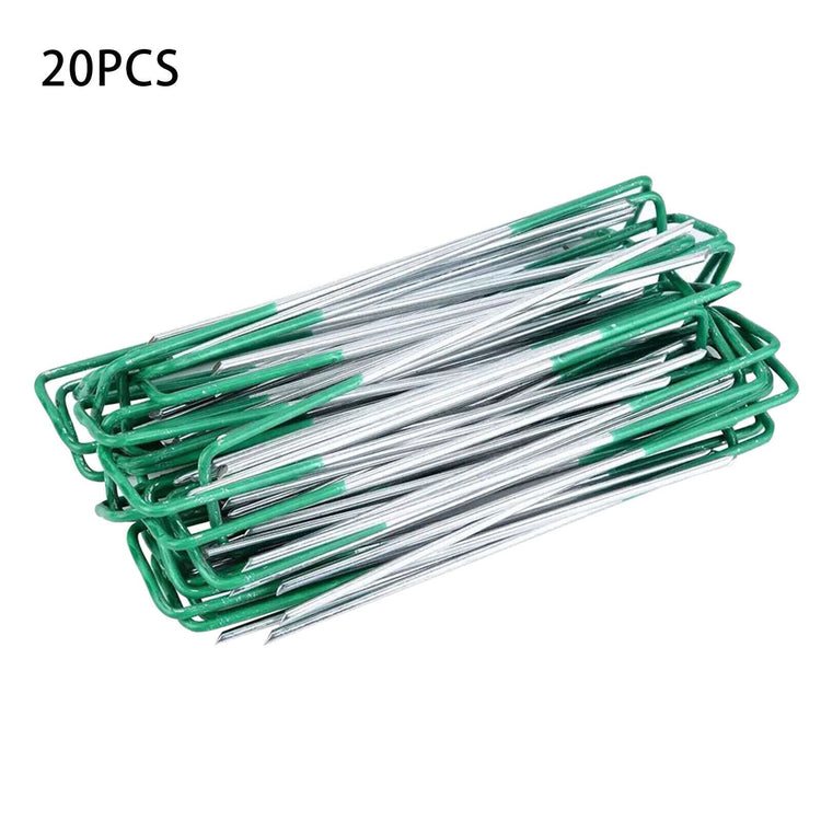 a pile of green and silver paper clips