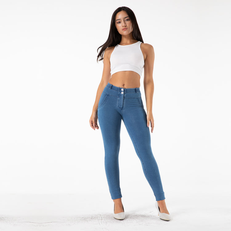 a woman in blue jeans and a white top