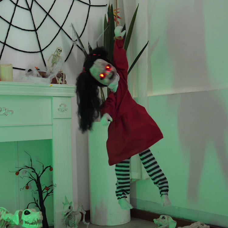 a doll in a red dress from a white fireplace