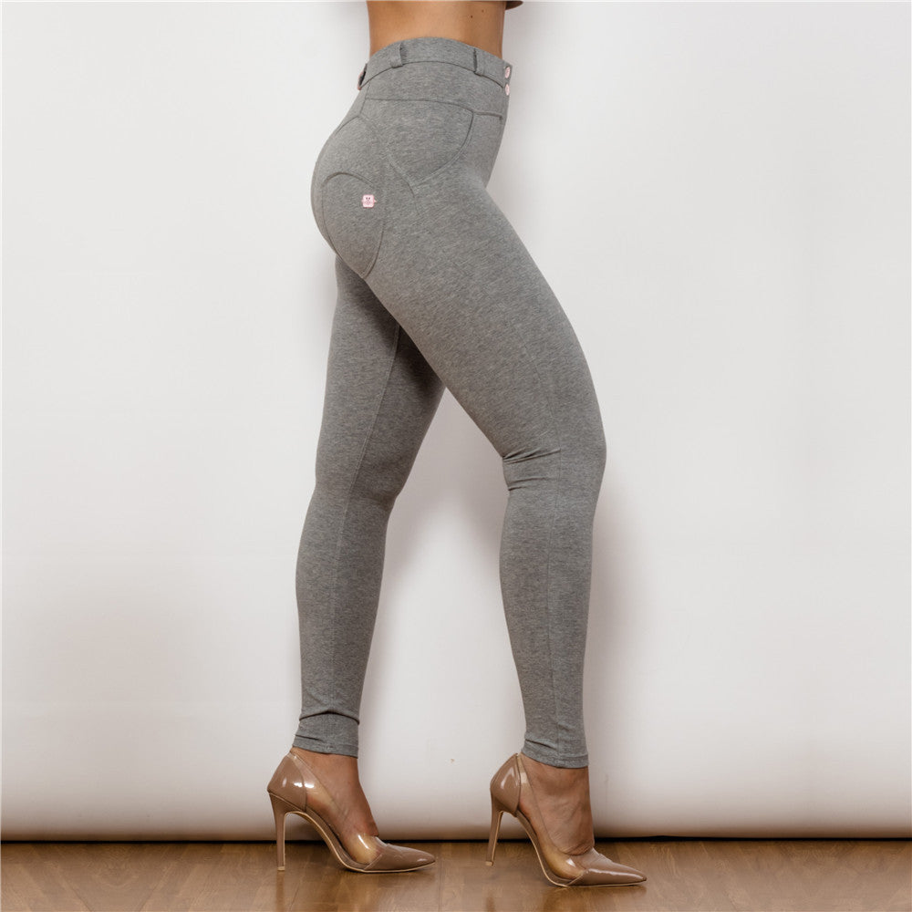a woman wearing grey pants and heels