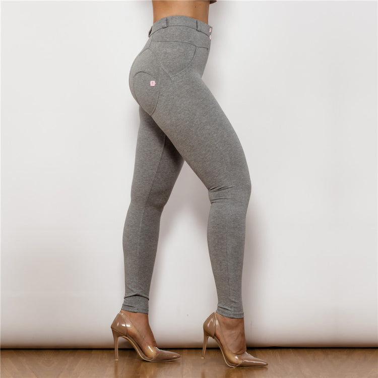 a woman wearing grey pants and heels