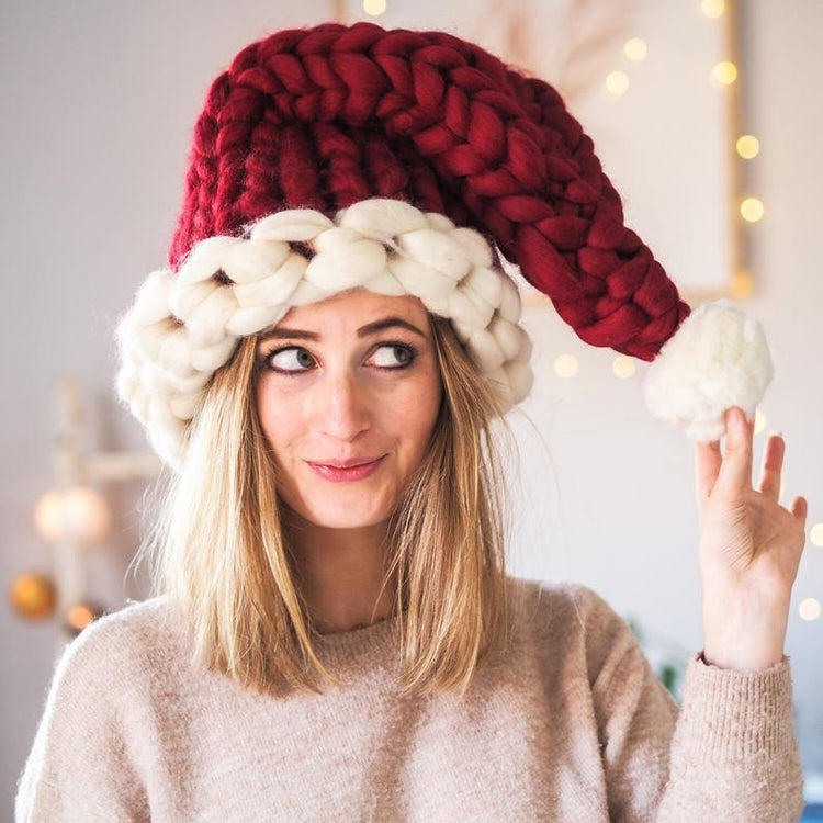 a woman wearing a red and white knit hat