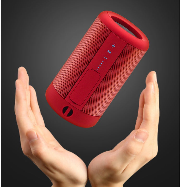 a hand holding a red speaker