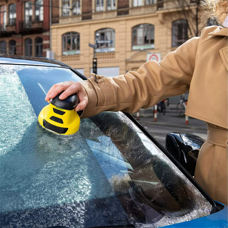 a person using a yellow object to clean a car window