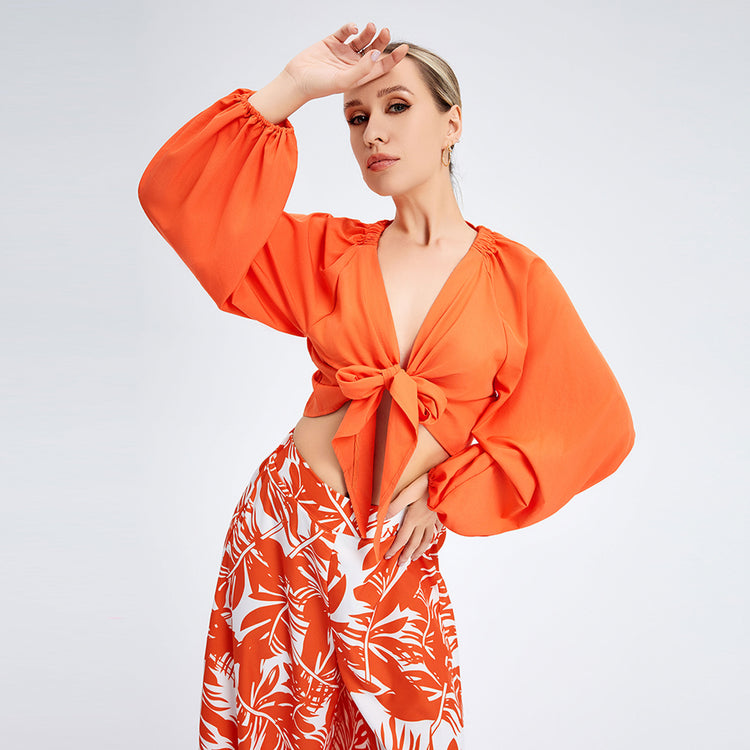 a woman in orange shirt and skirt