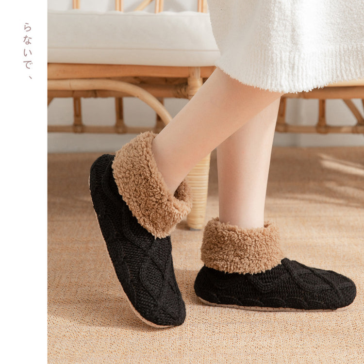 a person wearing black and brown slippers