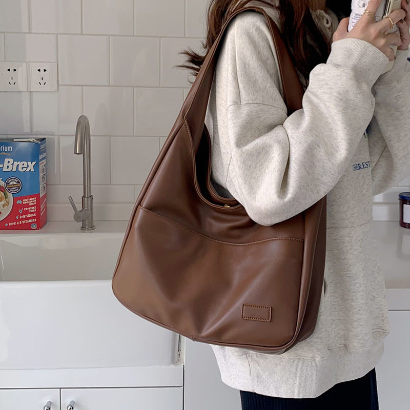 a woman holding a purse and a baby