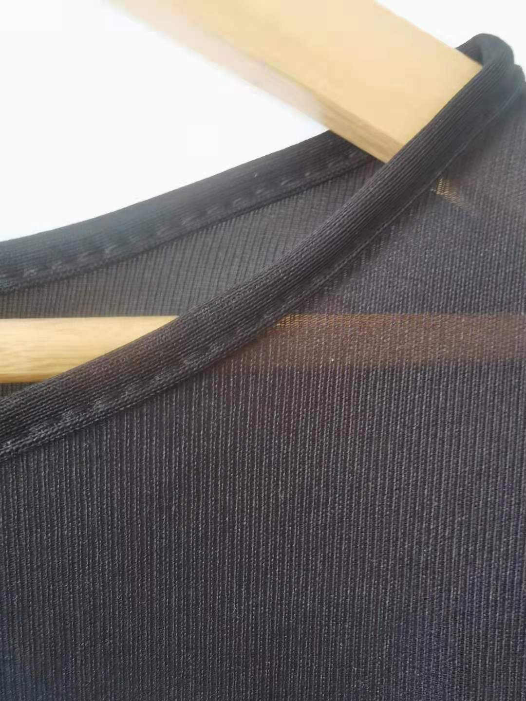 a black fabric with a wooden swinger